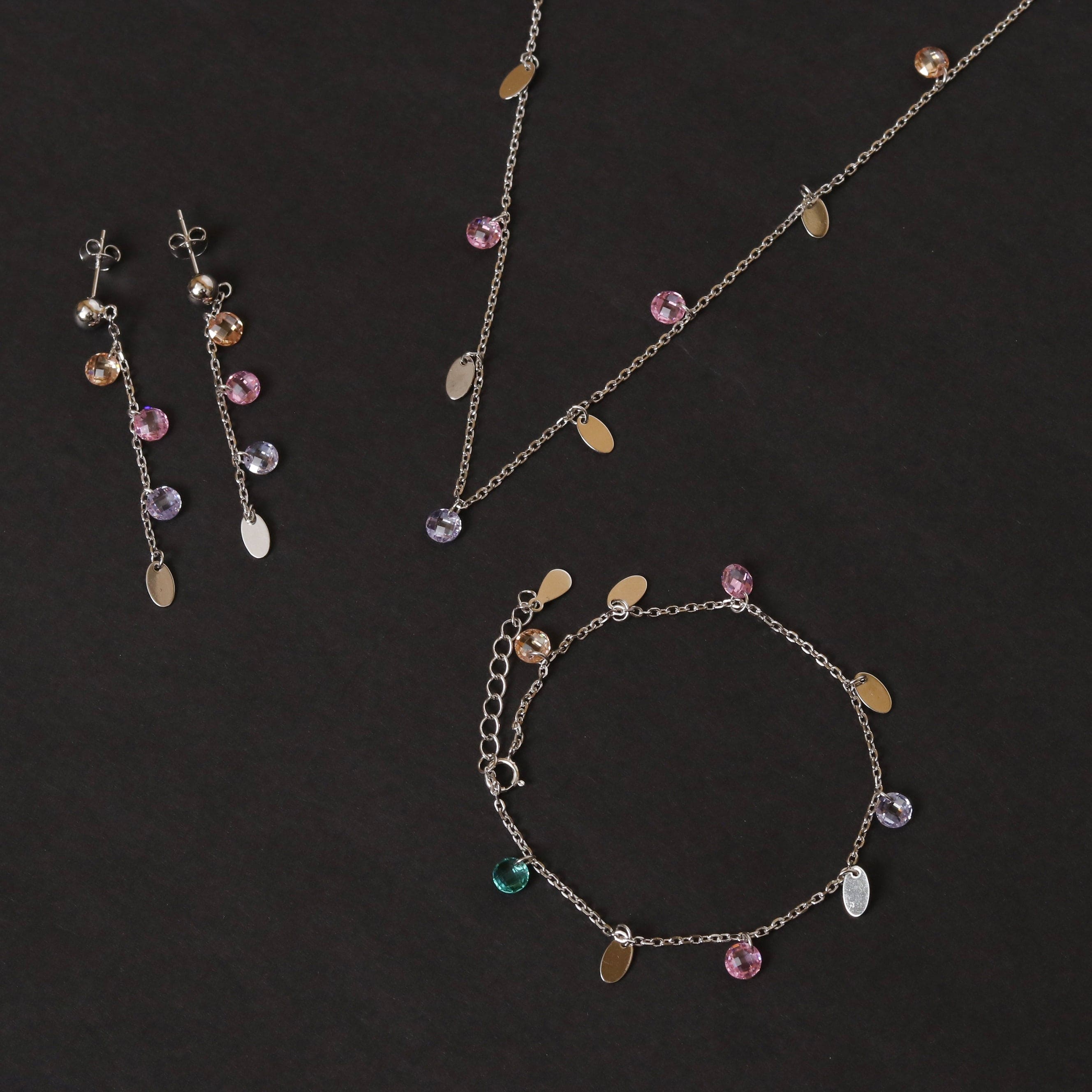 Silver-tone necklace and drop earrings with multicolor charm pendants, including purple and teal.