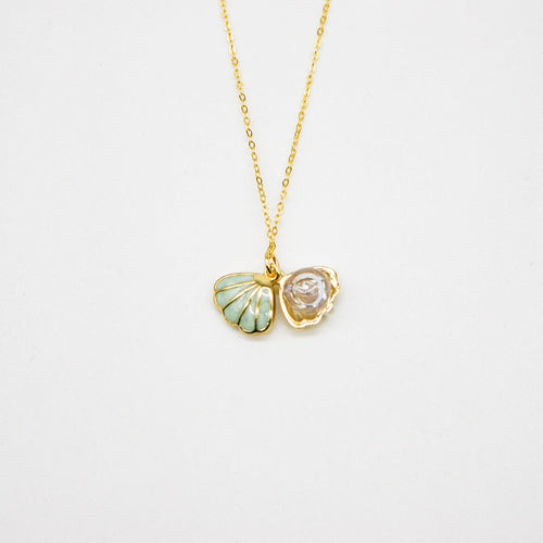 Gold-tone aroma necklace with green shell and clear swirl pendant